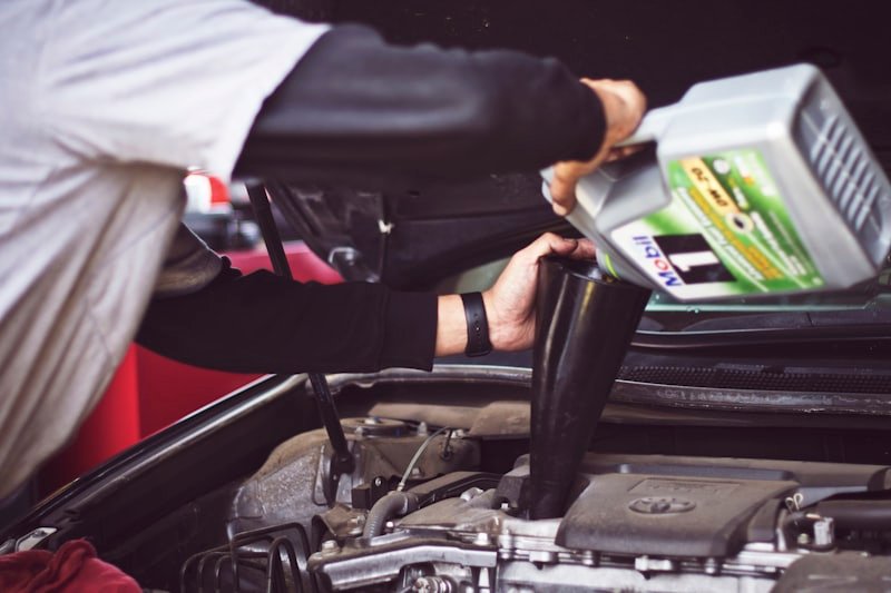 Engine bay open beside a technician's tool case