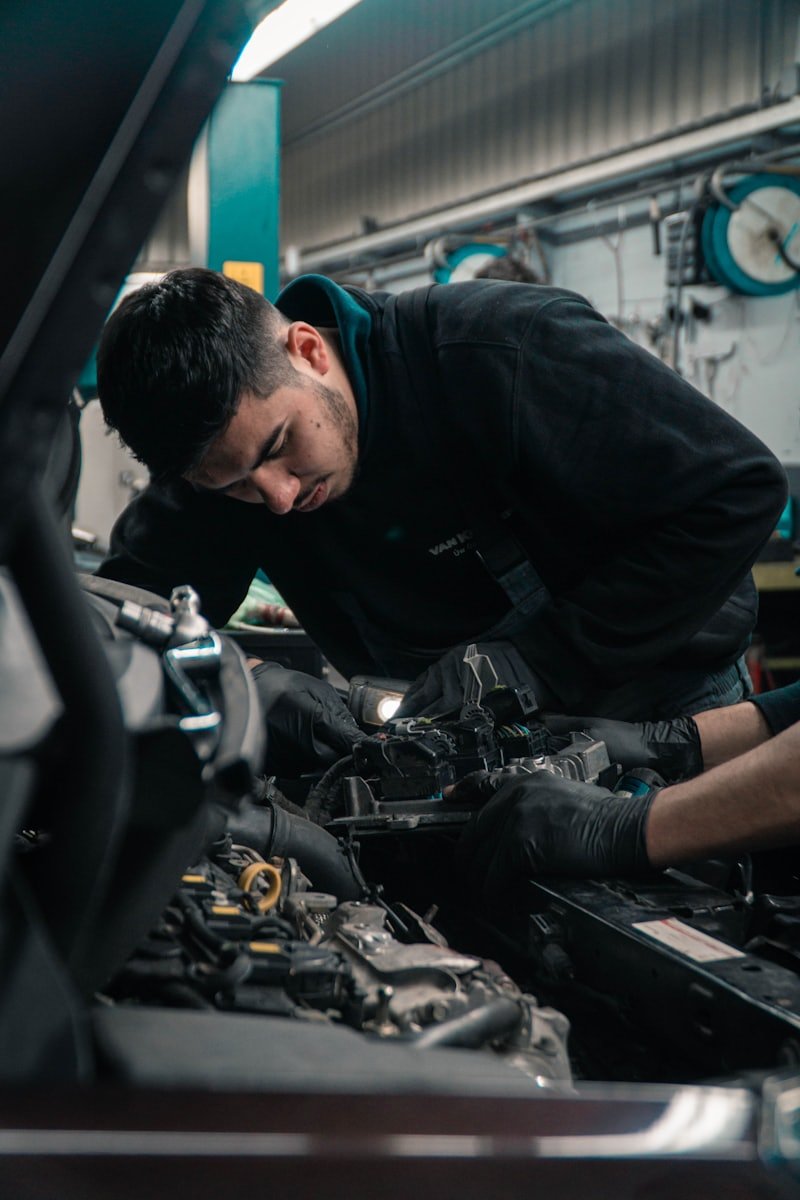 Mechanic servicing a vehicle engine